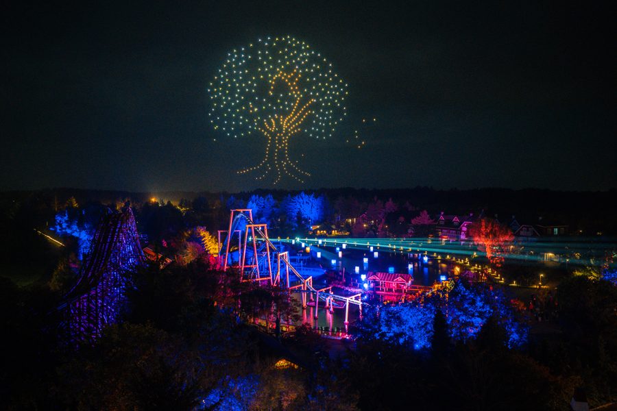 A tree of light over the park at night